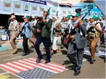  ?? AFP PHOTO ?? REBEL PARADE
Armed civil servants step on a United States flag as they take part in a parade following 12 days of military training in Yemen’s Houthi-run capital Sanaa on March 9, 2024.