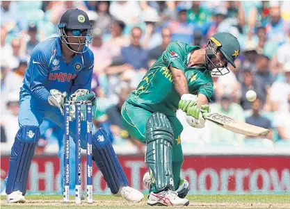  ??  ?? Pakistan’s Fakhar Zaman lofts the ball as India’s Mahendra Singh Dhoni looks on. India and Pakistan are among nine nations in the Test championsh­ip.