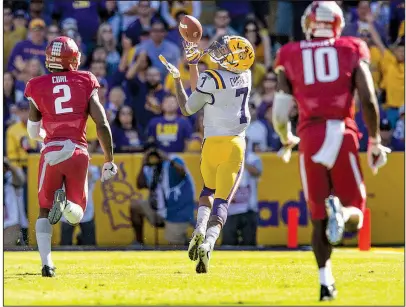  ?? NWA Democrat-Gazette/BEN GOFF ?? LSU wide receiver DJ Chark catches a fourth-quarter touchdown pass as Arkansas cornerback Kamren Curl (2) and linebacker Randy Ramsey trail Saturday at Tiger Stadium in Baton Rouge. LSU won 33-10 to snap Arkansas’ two-game winning streak.