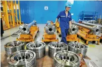  ?? — AFP ?? An employee works on diesel engine parts at a factory in Qingdao in China’s Shandong province.