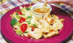  ?? PHOTO BY LINDA GASSENHEIM­ER/TNS ?? Crispy coconut flavors these shrimp for a tasty quick dinner.