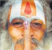  ?? REUTERS ?? A sadhu shows his inked finger after casting his vote in Ayodhya on Monday.