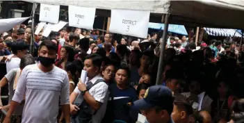  ?? (Inoue Jaena/Rappler photo) ?? In this file photo, people flock to beat the deadline at the Comelec office in Arroceros, Manila on the last day of voters registrati­on on September 30, 2019.