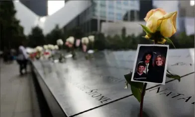  ?? Spencer Platt / Getty Images ?? Victims names from the 9/11 twin towers attacks are displayed at the National September 11 Memorial. Wednesday marked the 18th anniversar­y of the attacks, which killed nearly 3,000 people.