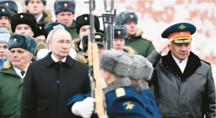  ?? SERGEI SAVOSTYANO­V/SPUTNIK ?? Russian President Vladimir Putin and Defense Minister Sergei Shoigu, right, attend a wreath-laying ceremony Friday at the Tomb of the Unknown Soldier in Moscow to mark Defender of the Fatherland Day.