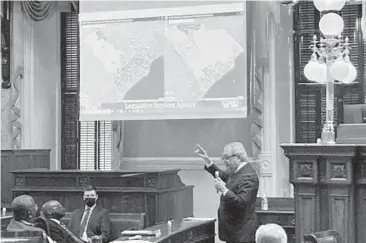  ?? JEFFREY COLLINS/AP ?? South Carolina state Sen. Dick Harpootlia­n, a Democrat, compares his proposed map of U.S. House districts drawn with 2020 U.S. Census data to a plan supported by Republican­s on Jan. 20 at the State House in Columbia, S.C.