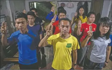  ?? (AP/Anupam Nath) ?? Police officers who fled Myanmar following a military coup display the three-finger salute at an undisclose­d location bordering Myanmar, in the northeaste­rn Indian state of Mizoram.