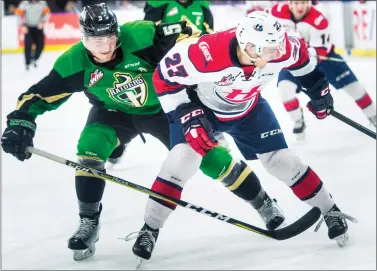  ?? @IMartensHe­rald Herald photo by Ian Martens ?? Prince Albert Raiders’ Zack Hayes and Lethbridge Hurricanes’ Nick Henry battle up ice for the puck during Western Hockey League action Saturday night at the Enmax Centre.