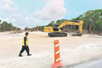  ?? — AFP file photo ?? A security guard walks at the constructi­on site of Section 5 South of the Mayan Train between the resorts of Playa del Carmen and Tulum which was halted by a district judge pending resolution of an injunction sought by scuba divers and environmen­talists – in the jungle in Playa del Carmen, Quintana Roo State, Mexico.