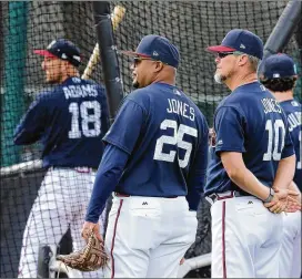  ?? CURTIS COMPTON / CCOMPTON@AJC.COM ?? Braves special assistants and former players Andruw Jones (left) and Chipper Jones watch batting practice earlier this week. Chipper Jones likes the power potential of prospects Ronald Acuna, Austin Riley and Alex Jackson.