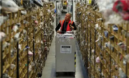  ?? Photograph: Matthew Horwood/Getty Images ?? An Amazon warehouse in Swansea. Analysts are forecastin­g quarterly revenues of almost £60bn.