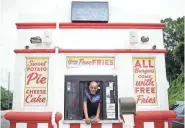  ?? CALVIN MATTHEIS/NEWS SENTINEL ?? The Burger Boys building on Chapman Highway is barely big enough for two people, but that’s all the space Andre Bryant needs. He has a potato cutter on the wall, two small deep fryers, a single grill and a burger-making station complete with his fresh toppings for the day.