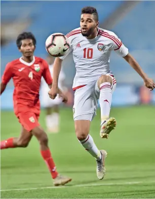  ??  ?? The UAE’s Jassim Al Blooshi controls the ball during the match against the Maldives.