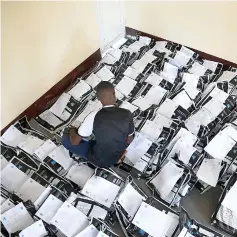  ??  ?? A man classifies voting materials at Congo’s Independen­t National Electoral Commission (CENI) tallying centre in Kinshasa. — Reuters photo