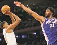  ?? Seth Wenig / Associated Press ?? The 76ers’ Joel Embiid tries to block a shot by Knicks guard Frank Ntilikina during the second half Sunday.