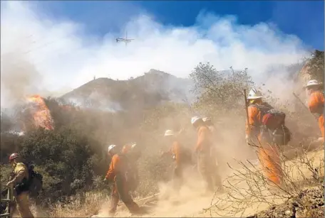  ?? Photog r aphs by Michael Robinson Chavez
Los Angeles Times ?? MORE THAN 450 f iref ighters were deployed to the area. The f ire’s plume of smoke was visible from miles around, prompting air quality off icials to issue an advisory. By nightfall, f ire crews had the upper hand and residents were allowed back to...