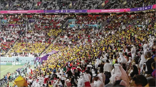  ?? TASNEEM ALSULTAN/NEW YORK TIMES 2022 ?? Attendees watch the first game of the 2022 FIFA World Cup between Qatar and Ecuador at Al Bayt Stadium in Al Khor, Qatar, on Nov. 20. In 2026, Canada will join the U.S. and Mexico in playing host to the tournament, the largest in history, with 48 teams and 104 matches.