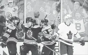  ?? MICHAEL DWYER THE ASSOCIATED PRESS ?? Boston Bruins’ David Krejci (46) celebrates his goal with teammates Brad Marchand (63) and David Pastrnak as Toronto Maple Leafs’ Nikita Zaitsev skates away during the third period Saturday. Krejci had a goal and an assist to pass Hall of Famer Cam Neely for 10th on the Bruins’ all-time scoring list.