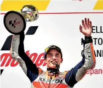  ??  ?? Repsol Honda Team Spanish rider Marc Marquez celebrates on the podium with the trophy after winning the Malaysia Motogp at the Sepang Internatio­nal Circuit