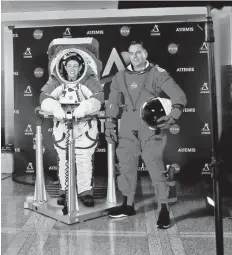  ?? — Reuters photo ?? Davis wears the xEMU space suit next to lead engineer Dustin Gohmert wearing the Orion crew survival spacesuit prototype for the next astronaut to the moon by 2024, during a presentati­on at Nasa headquarte­rs in Washington.