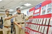  ?? — DC ?? Hyderabad police commission­er Anjani Kumar, task force additional DCP S. Chaitanya Kumar inspect documents recovered from accused Srinivas Rao.