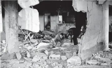  ?? KHALED OMAR Xinhua / USA TODAY NETWORK ?? People inspect the rubble after an Israeli airstrike in the southern Gaza Strip city of Rafah, on Saturday. The Israeli military has been launching intensive airstrikes on Rafah city in the south of Gaza since Friday night, killing at least 44 people, the state-run Palestine TV reported. Hundreds of thousands of Gazans have sought shelter there from the war.