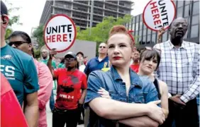  ?? AP PHOTO BY JACQUELINE LARMA ?? Amanda Hammock, center, a Delaware County, Pa., Democratic Party activist, is dressed as Rosie the Riveter as she attends a protest by Philadelph­ia Council AFL-CIO Wednesday, in Philadelph­ia. The protesters denounced Wednesday’s U.S. Supreme Court...