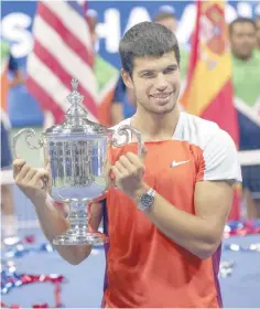  ?? REUTERS ?? CARLOS Alcaraz of Spain poses with the victor’s trophy after beating Casper Ruud of Norway in the men’s singles final at the US Open tennis tournament in New York on Sept. 11, 2022.