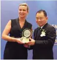  ??  ?? Lai receives the award from Reader’s Digest group advertisin­g director (Asia Pacific region) Sheron White.