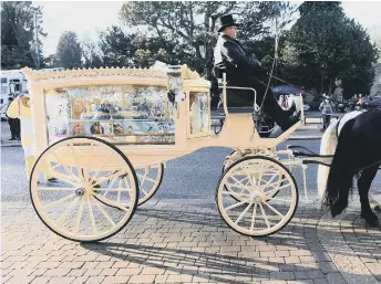  ??  ?? The white carriage that carried Sheldon’s coffin was decorated with Paw Patrol characters.