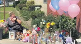  ?? ELIZABETH CHOU — STAFF ?? Blanca Naranjo is overcome with emotion Sunday amid an impromptu memorial to three children found dead in Reseda. The mother of the children has been arrested.