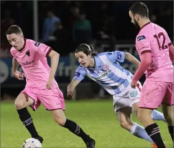  ??  ?? Conor Sutton breaks away from Shelbourne’s Adam Evans as Shane Dunne looks on approvingl­y.