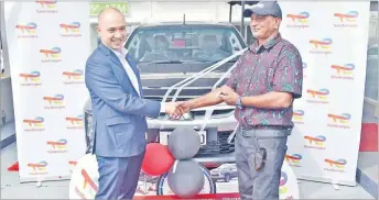  ?? Picture: JONACANI LALAKOBAU ?? TotalEnerg­ies Marketing (Fiji) managing director Dennis Michael Cuaycong hands over the car key to Ritesh Kumar at the TotalEnerg­ies Flagstaff Service Station in Suva yesterday.