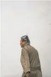  ?? Gabrielle Lurie / The Chronicle ?? A plastic bag shields a man’s head from rain as he walks through Chinatown in S.F.