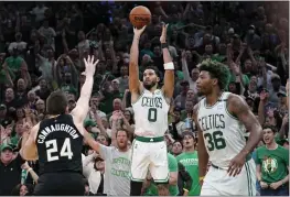  ?? STEVEN SENNE — THE ASSOCIATED PRESS ?? Boston Celtics forward Jayson Tatum (0) takes a shot at the basket as Milwaukee Bucks guard Pat Connaughto­n (24) defends while Celtics guard Marcus Smart (36) looks on during the second half of Game 7of an Eastern Conference semifinals playoff series Sunday in Boston. The Celtics won 109-81.