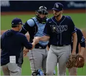  ?? AP PHOTO BY JAE C. HONG ?? Tampa Bay Rays starting pitcher Ryan Thompson, right, hands the ball to manager Kevin Cash, left, as he is pulled during the second inning in Game 4 of a baseball American League Division Series against the New York Yankees, Thursday, Oct. 8, 2020, in San Diego.