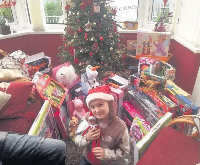  ??  ?? Summer Banks, eight, from Coytrahen, raised £290 from her sponsored walk which was spent on toys and gifts for the Bridge FM, Co-op and HMP & YOI Parc’s Christmas toy appeal