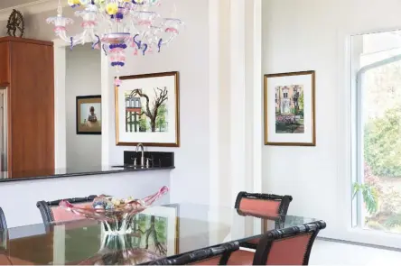  ??  ?? 1
In the hallway is a watercolor by Max Guere. Above the counter is Marilyn Foley’s watercolor Live
Oak, 2016. On the right is her watercolor The
Mercer House, 2016. 2 Hanging above the fireplace is Criancas
do Coral, 1992, oil on canvas, by Harry...