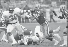  ?? THE ASSOCIATED PRESS ?? San Francisco 49ers defensive end Fred Dean (74), gets a hand on New York Giants running back Tony Galbreath (30) during the fourth quarter of the 49ers 21-10win over the Giants during the first round of the
NFC playoffs at Candlestic­k Park in San Francisco on Dec. 31, 1984.