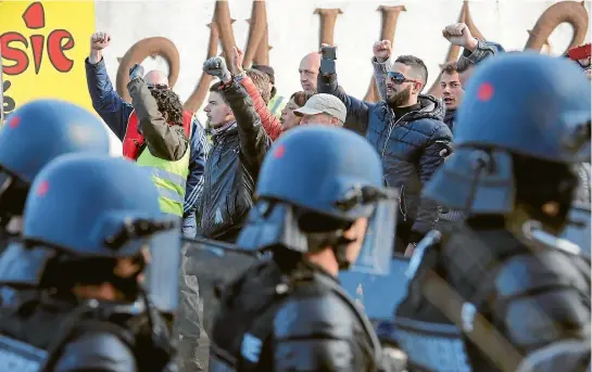  ?? PHOTO: REUTERS ?? French gendarmes take up position after striking workers blockaded roads near the oil refinery at Fos-sur-Mer, near Marseille.