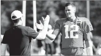  ?? Detroit News/Daniel Mears ?? Detroit Lions general manager Bob Quinn (left) greets New England Patriots quarterbac­k Tom Brady on Monday during a combined NFL practice in Allen Park, Mich.