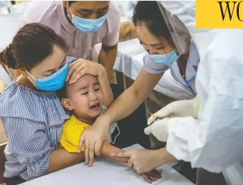  ?? GETTY IMAGES ?? Medical specialist­s collect blood for a coronaviru­s rapid test from people who recently returned from Danang on
Friday in Hanoi, Vietnam. A cluster of new cases surfaced in Danang, a popular central resort city, a week ago.