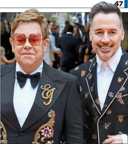  ??  ?? PUBLIC EYE: Sir Elton John and David Furnish at The Lion King’s London premiere in July