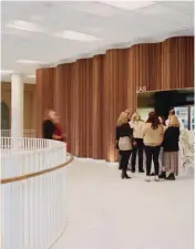  ??  ?? In the Playhouse foyer, the undulating, rounded timber battens that wrap the theatre are set off by white floors and ceilings.