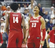  ?? Associated Press ?? Alabama forward Nick Pringle (23) reacts after defeating Auburn in an NCAA college basketball game, Saturday, in Auburn, Ala. The Crimson Tide is ranked No. 1 in Monday’s AP Top 25 poll.