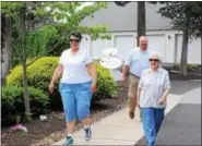  ?? MICHILEA PATTERSON — DIGITAL FIRST MEDIA ?? David Hallman, Sanatoga Ridge Community administra­tor, walks with two women part of the Trail Blazers group through the retirement neighborho­od. Sanatoga Ridge uses a wellness community outreach program to help older adults age healthy.