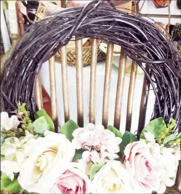  ??  ?? A wreath made of artificial flowers and dried grape vines.