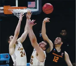  ?? JEFF ROBERSON – THE ASSOCIATED PRESS ?? Oregon State’s Roman Silva, right, fights for a rebound with Loyola Chicago’s Tate Hall, left, and Cameron Krutwig during Saturday’s NCAA Tournament Sweet 16 game.