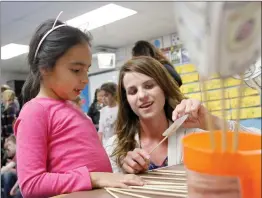  ?? Nikolas Samuels/The Signal ?? Giselle De Leon, 6, works with kindergart­en teacher Christina Rohr on language skills during the Family Literacy Night at Leona Cox Community School in Canyon Country on Wednesday.