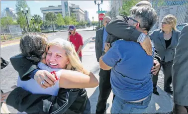  ?? AP PHOTO ?? Susan Adieh, left, cousin, and other family members of Noor Salman receive hugs from friends Friday after a jury found Salman not guilty on all charges at the Orlando Federal Courthouse, in Orlando, Fla.